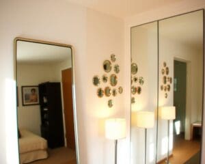 What mirrors add light and depth to small rooms?
